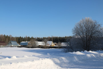 Fototapeta na wymiar Village in a winter day and snow