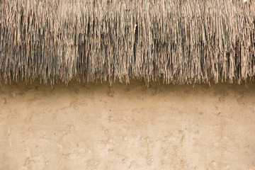 straw thatched roof  and  soil wall background - 109844874