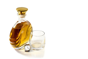 Bottle whiskey with tumbler and watch on  white background