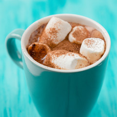 Cocoa with melted marshmallow in light blue cup