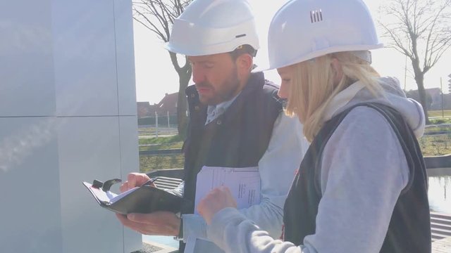 View of a Worker and enginner checking last details before delivery