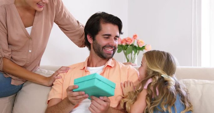 Daughter giving a present to her father 