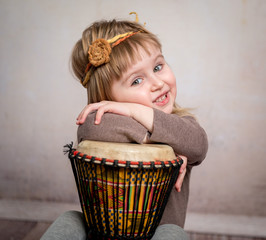 cute little girl playing drum