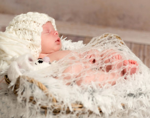 lovely newborn baby in knitted white hat