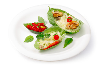 Boiled rice (risotto) served into basil leaves