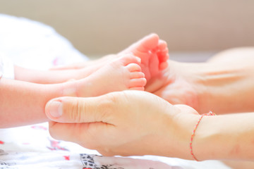 Baby feet in mother hands. Happy Family concept. Tiny Newborn Ba