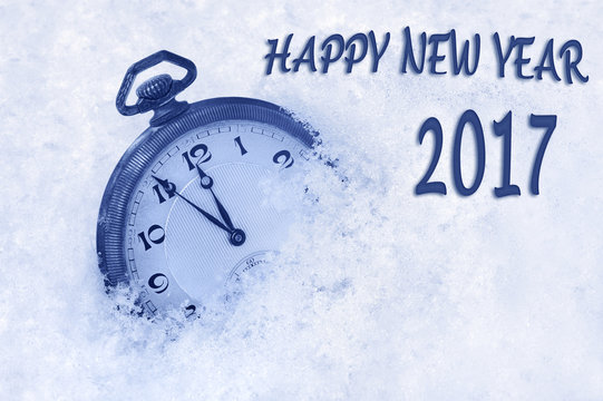 New Year 2017 greeting in English language, pocket watch in snow, happy new year 2017 text