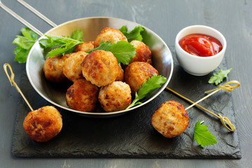 Homemade meatballs with tomato sauce and salad.