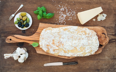 Freshly baked ciabatta bread with garlic, mediterranean olives, basil and Parmesan cheese