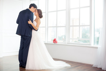 Fototapeta premium Bride and groom in very bright room