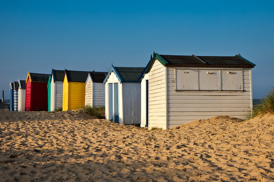 A row of brightly coloured beach huts in Southwold Suffolk