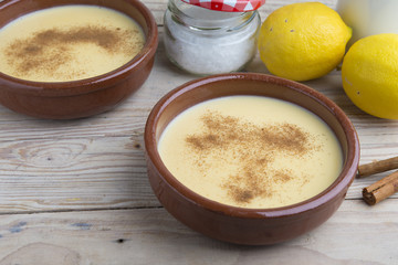 Traditional creme brulee on ceramic dish on wooden table