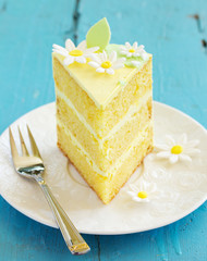 A piece of lemon sponge cake on a plate.