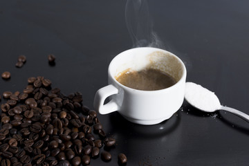 small white cup of steaming espresso.