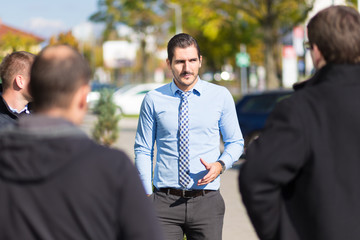 Businessman being approached and blackmailed by racketeers.