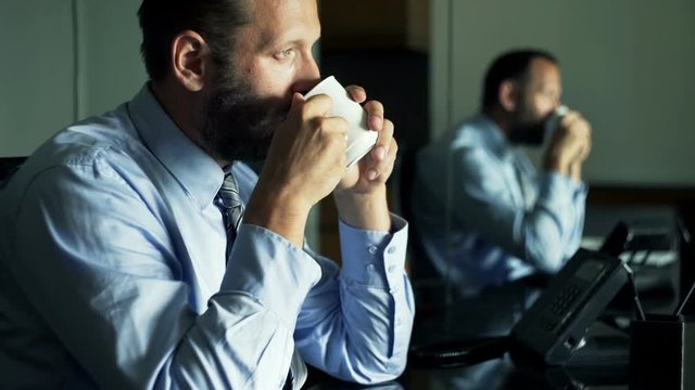 Young businessman relaxing and drinking tea in office 
