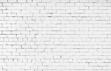 Brick wall painted in white color. Texture of the brickwork. White brick wall background.