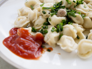 Dumplings ketchup and chives.