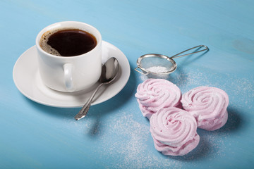 Fresh pink homemade zephyr - marshmallow and white cup of tea on