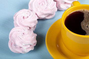 Fresh pink homemade zephyr - marshmallow and cup of coffee on bl