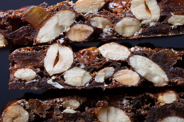Traditional italian christmas dessert Panforte on dark backgroun