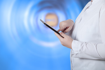 A woman in a white uniform robe with electronic device in her ha