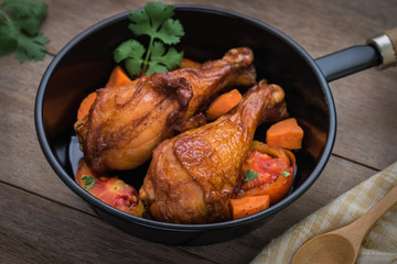 Grilled chicken legs and vegetables in pan