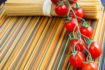 Colored italian spaghetti with mini tomatoes