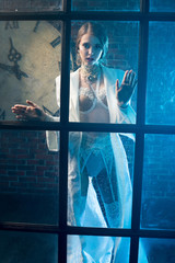 Beautiful woman ghost behind the glass