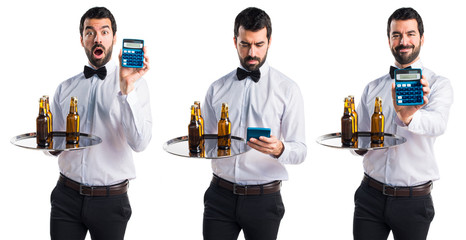 Waiter with beer bottles on the tray holding a calculator