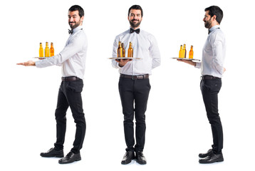 Waiter with beer bottles on the tray