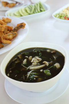 Mushroom curry with herb juice in white bowl, Thai food, Esan st