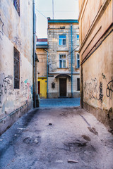 Fototapeta na wymiar dirty alley with graffiti