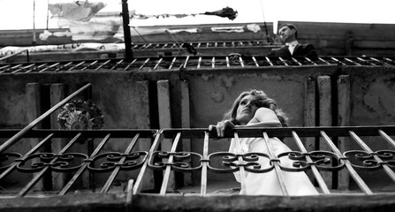 Woman and man stand on the different  floors and on the differen