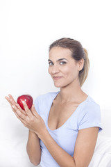 Beautiful woman with red apple in hand