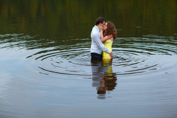 Man kisses a woman standing in water