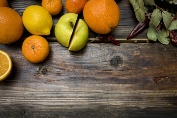 lemon and orange in a white plate on a vintage wooden background