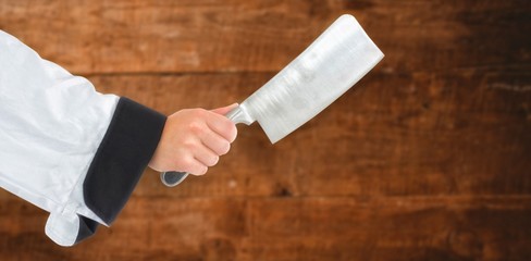 Composite image of chef hand holding a knife