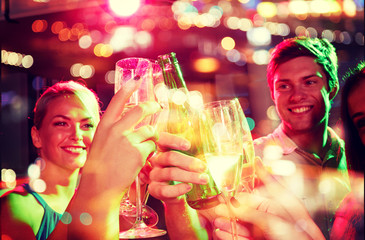 smiling friends with wine glasses and beer in club