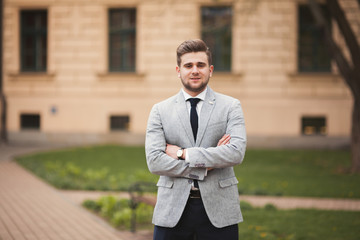 Handsome stylish young businessman posing portrait outdoor