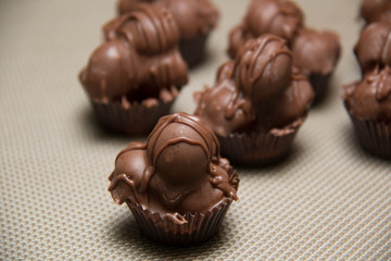  chocolate macadamia nut fudge against background.