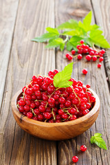 Berries red currants on a wooden background.
