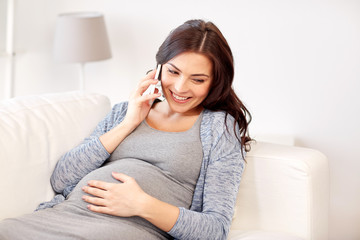 happy pregnant woman calling on smartphone at home