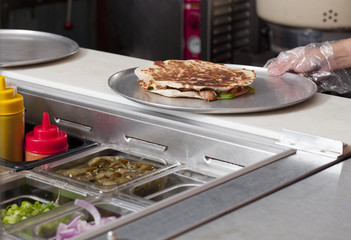 cropped image of a chef preparing burrito.