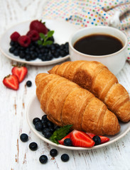 Fresh berries, coffee and croissant