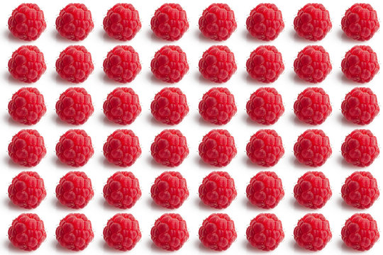 Small raspberries arranged in symmetric pattern on white background 