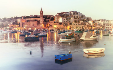 Fototapeta na wymiar Fisherman and passenger boats in Marsaskala bay in Malta