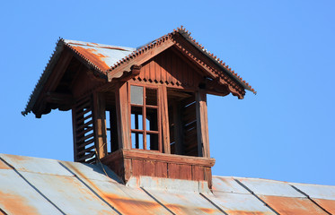 Old wooden attic window on the roof
