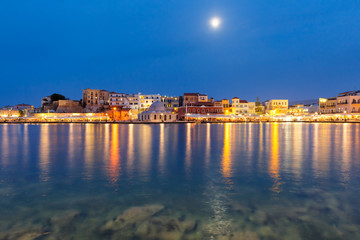 Fototapeta na wymiar Picturesque view of Venetian quay of Chania with Kucuk Hasan Pasha Mosque during twilight blue hour, Crete, Greece