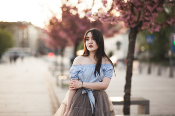 Fototapeta premium Young Asians girl with modern dress posing in an old Krakow